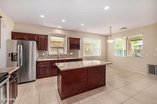 8214 S 48th Dr, Laveen, AZ 85339 - kitchen with stainless steel fridge with ice dispenser, a sink, backsplash, pendant lighting, and a kitchen island