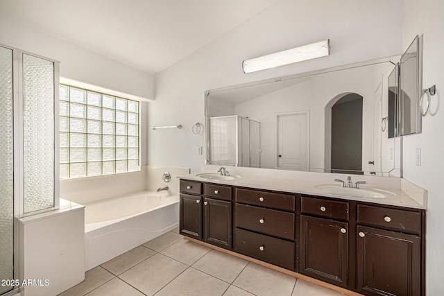 8214 S 48th Dr, Laveen, AZ 85339 - full bathroom with lofted ceiling, tile patterned floors, a garden tub, and double vanity