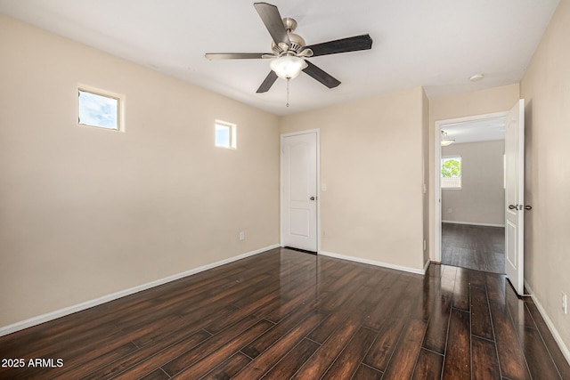 8214 S 48th Dr, Laveen, AZ 85339 - spare room featuring wood finished floors, healthy amount of natural light, a ceiling fan, and baseboards