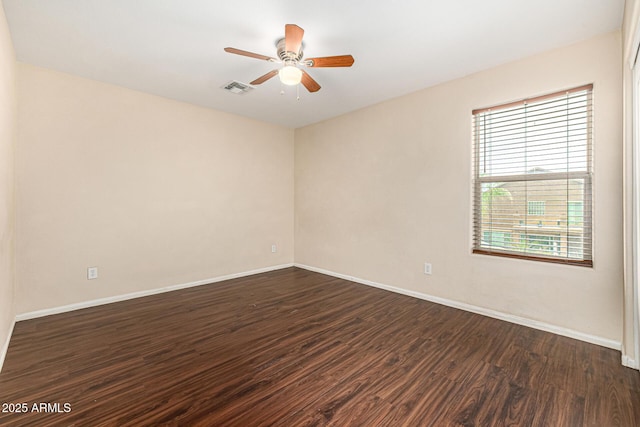 8214 S 48th Dr, Laveen, AZ 85339 - spare room with dark wood-style flooring, baseboards, and a ceiling fan