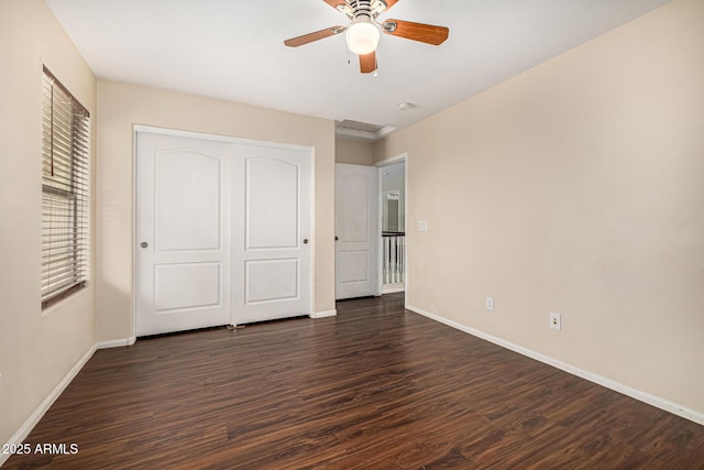 8214 S 48th Dr, Laveen, AZ 85339 - unfurnished bedroom with baseboards, dark wood-style flooring, a closet, and ceiling fan