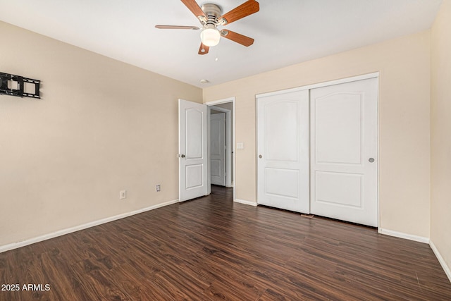 8214 S 48th Dr, Laveen, AZ 85339 - unfurnished bedroom featuring baseboards, dark wood-type flooring, a closet, and a ceiling fan