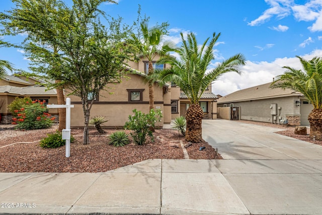 8214 S 48th Dr, Laveen, AZ 85339 - view of front of house featuring stucco siding, concrete driveway, and a tiled roof