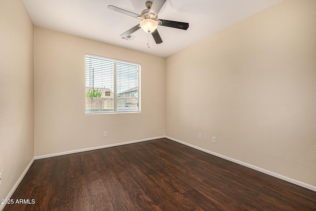 8214 S 48th Dr, Laveen, AZ 85339 - unfurnished room with dark wood finished floors, baseboards, and a ceiling fan