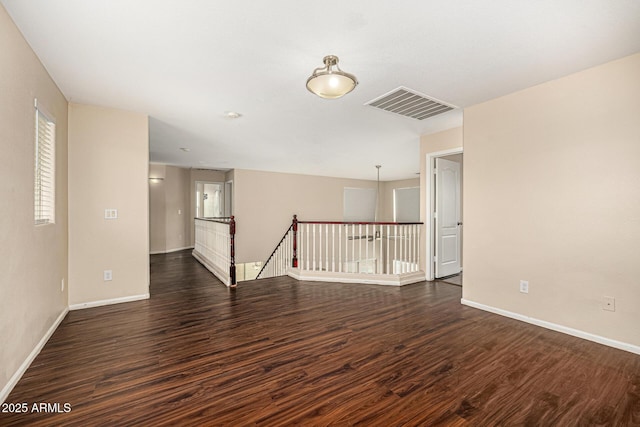 8214 S 48th Dr, Laveen, AZ 85339 - empty room featuring dark wood-type flooring and baseboards