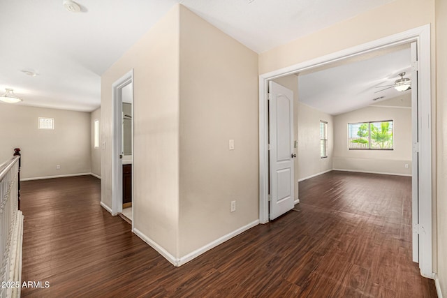 8214 S 48th Dr, Laveen, AZ 85339 - hall featuring dark wood-type flooring, lofted ceiling, and baseboards