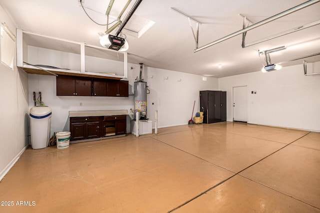 8214 S 48th Dr, Laveen, AZ 85339 - garage with a garage door opener, gas water heater, and baseboards