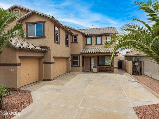 8214 S 48th Dr, Laveen, AZ 85339 - view of front of property featuring a tiled roof, a garage, stucco siding, and covered porch