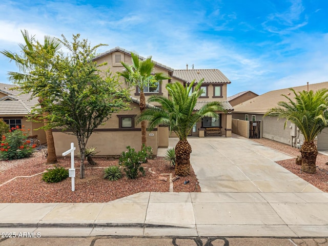 8214 S 48th Dr, Laveen, AZ 85339 - view of front of home with a tiled roof, stucco siding, and concrete driveway