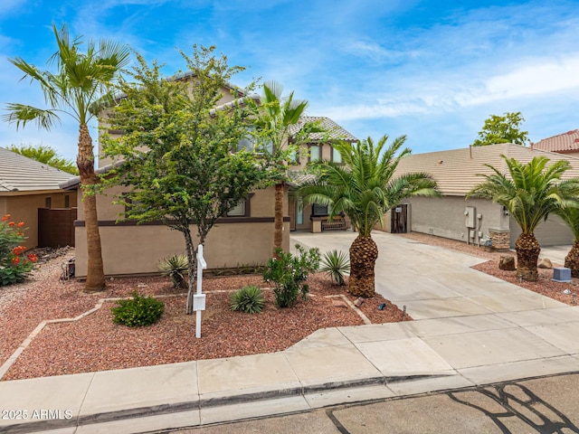 8214 S 48th Dr, Laveen, AZ 85339 - view of front facade with driveway, stucco siding, and a tiled roof