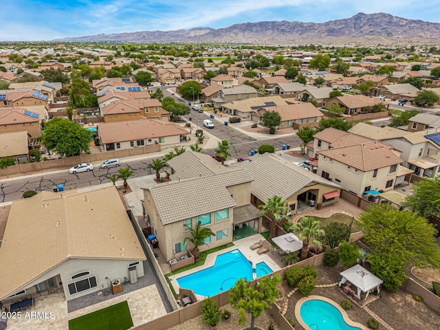 8214 S 48th Dr, Laveen, AZ 85339 - aerial perspective of suburban area with a pool area and a mountain backdrop