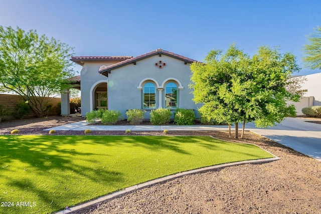 mediterranean / spanish house with a front yard