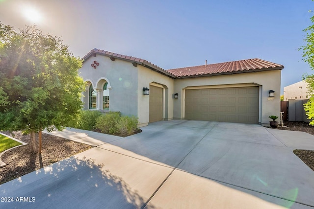 mediterranean / spanish house featuring a garage