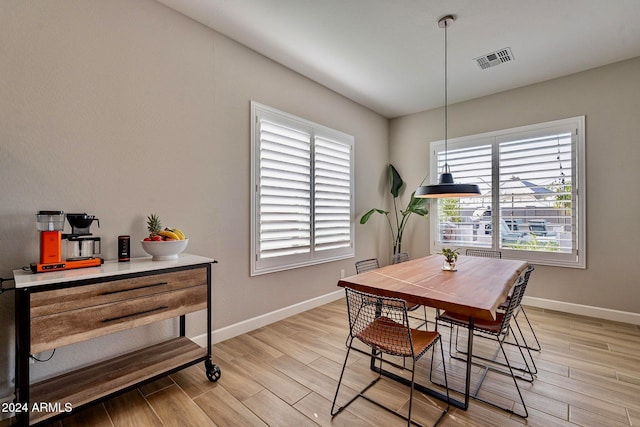 dining space with light hardwood / wood-style floors and plenty of natural light