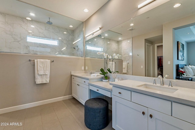 bathroom featuring vanity, tile patterned floors, and tiled shower