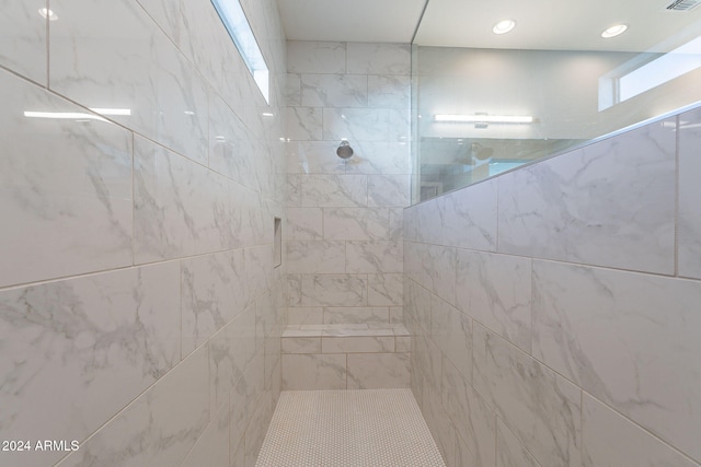 bathroom with a tile shower