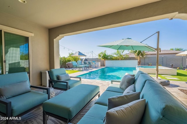 view of pool with pool water feature, a patio, and an outdoor hangout area