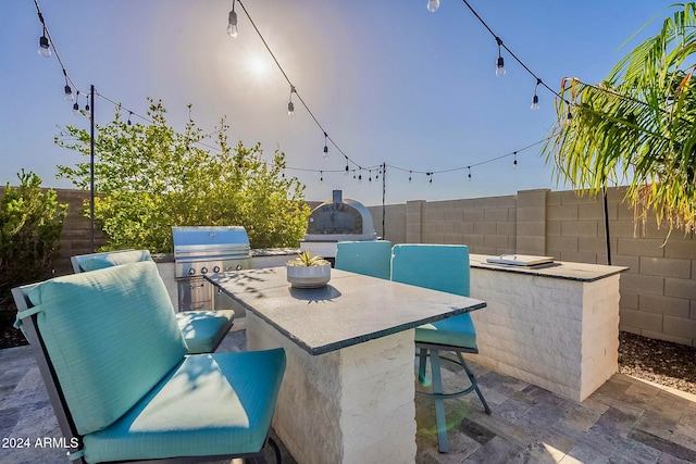 view of patio / terrace with exterior bar, an outdoor kitchen, and grilling area