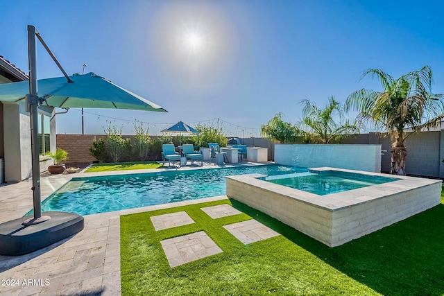 view of pool featuring a lawn, an in ground hot tub, and a patio area