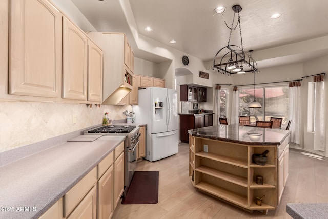 kitchen with stainless steel stove, open shelves, hanging light fixtures, white fridge with ice dispenser, and dark countertops