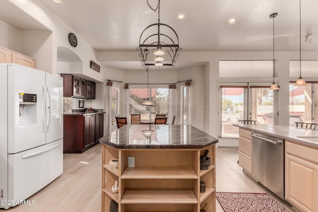 kitchen featuring white fridge with ice dispenser, a center island, stainless steel dishwasher, and open shelves