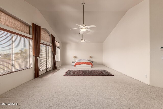 interior space with high vaulted ceiling, light colored carpet, and a ceiling fan