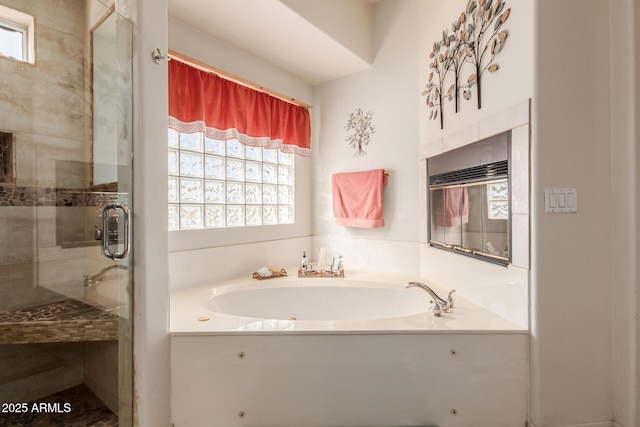bathroom featuring a garden tub and a shower stall