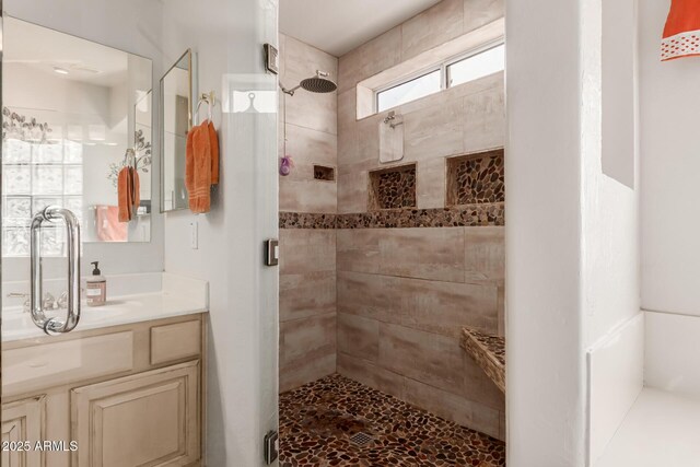 full bathroom featuring a shower stall and vanity