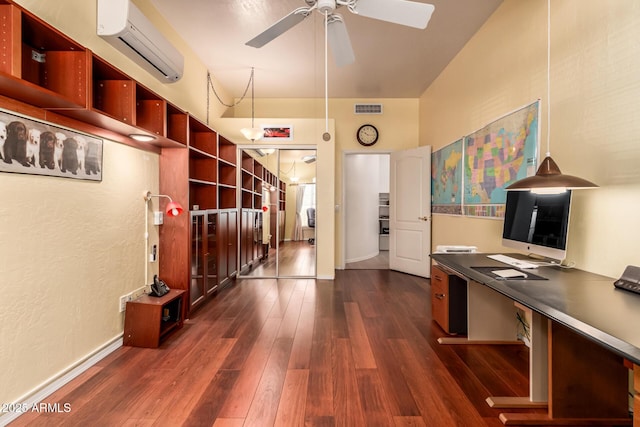 office featuring ceiling fan, dark wood-type flooring, a wall mounted AC, and visible vents