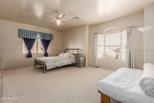 bedroom with ceiling fan, multiple windows, and visible vents
