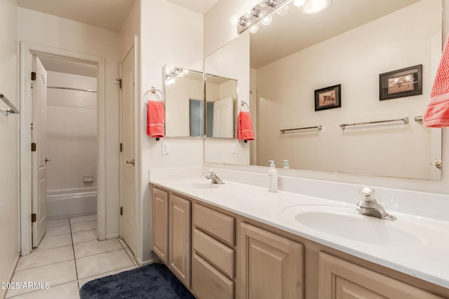bathroom with double vanity, shower / bathing tub combination, a sink, and tile patterned floors