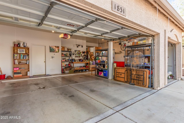 garage with a workshop area and a garage door opener