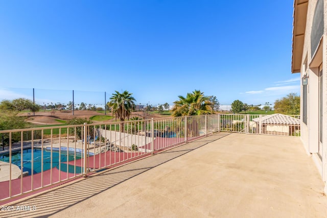 view of patio featuring fence and an outdoor pool