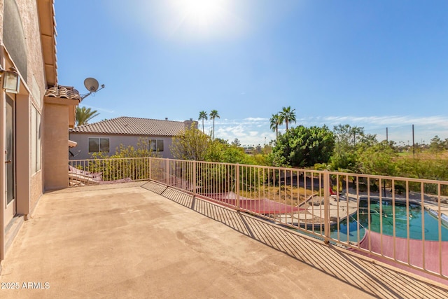 view of patio / terrace featuring fence and an outdoor pool