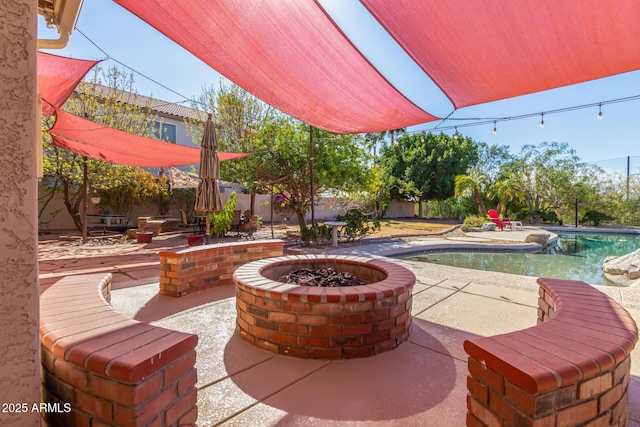 view of patio / terrace with an outdoor fire pit, a fenced in pool, and a fenced backyard