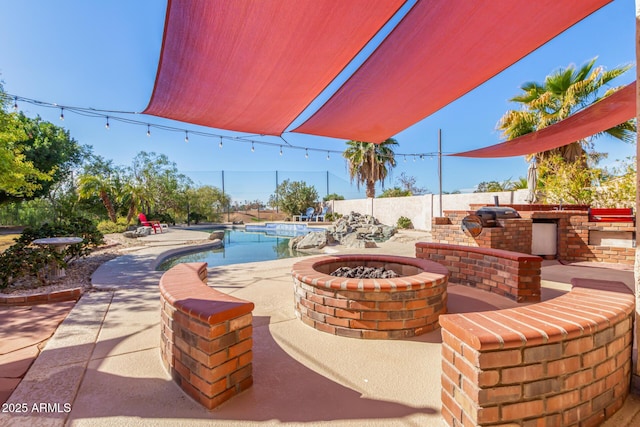 view of patio featuring an outdoor fire pit, area for grilling, a fenced backyard, and a fenced in pool