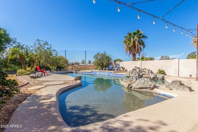 view of swimming pool with a fenced backyard and a fenced in pool