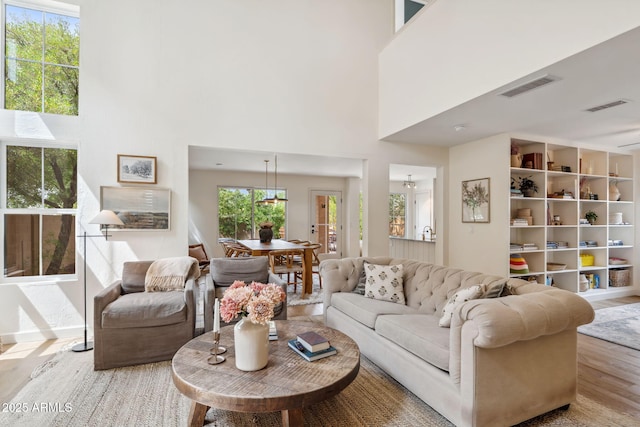 living area featuring a high ceiling and wood finished floors