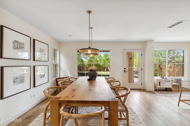 dining room with light wood-style floors and baseboards