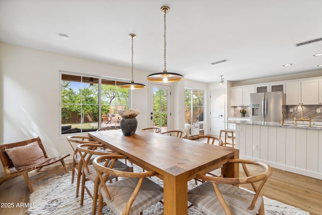 dining area featuring light wood-style floors and recessed lighting