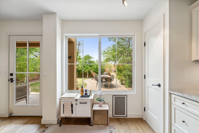 entryway featuring light wood-style floors and baseboards