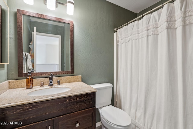 full bathroom with toilet, vanity, a textured wall, and a shower with curtain