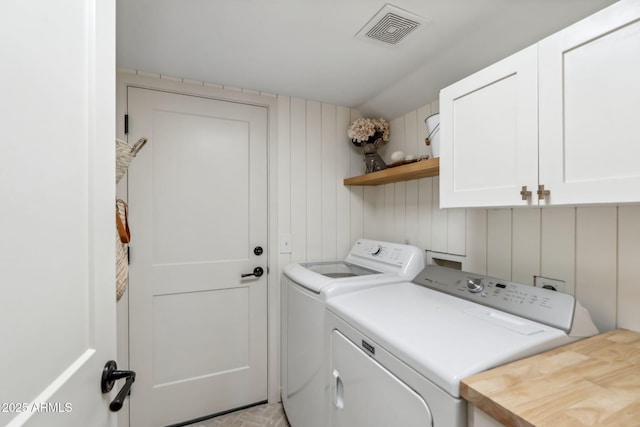 laundry room featuring cabinet space and washing machine and dryer