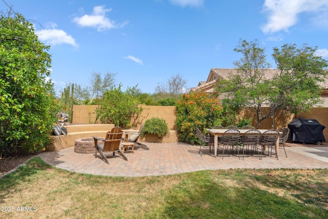 view of patio featuring area for grilling and an outdoor fire pit