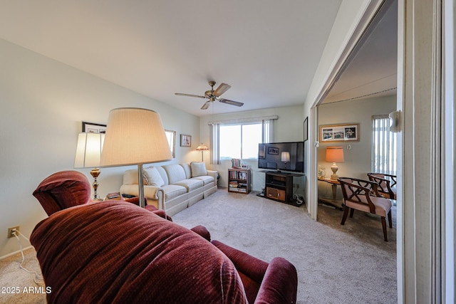 carpeted living room with ceiling fan