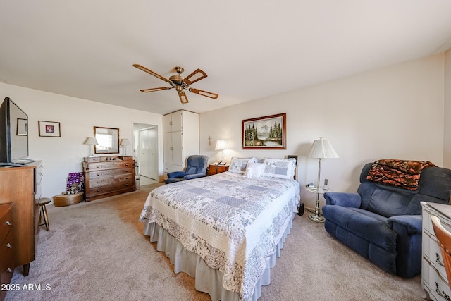 bedroom with ceiling fan and light colored carpet