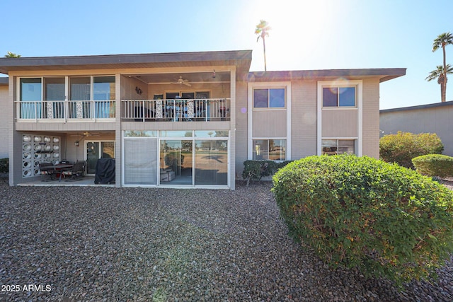 back of house with a balcony and a patio area