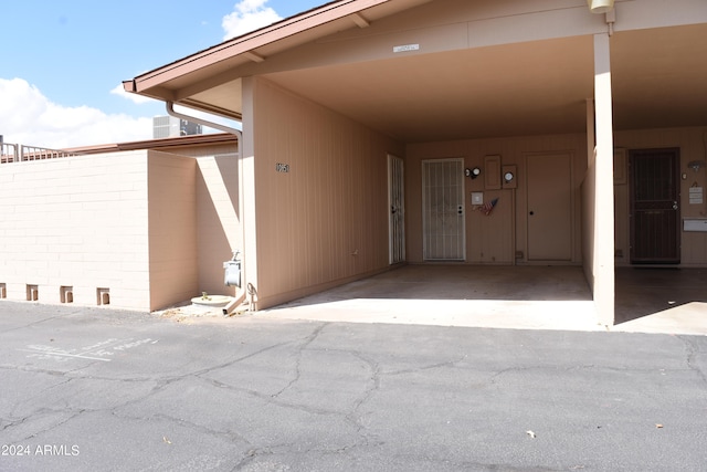 doorway to property with a carport