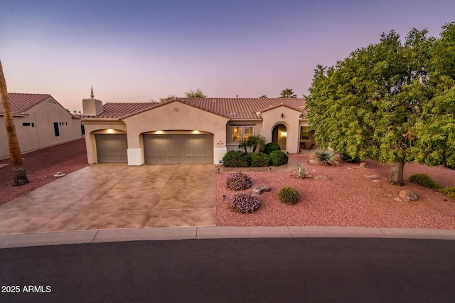 mediterranean / spanish house featuring a garage