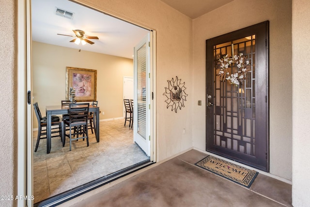 property entrance featuring ceiling fan